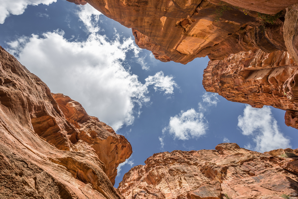 The sky viewed from within a rock chasm.  It is an intense blue with white clouds.

Taken from ttps://depositphotos.com/photo/observing-sky-from-the-canyon-in-the-ancient-city-of-petra-jord-108569408.html