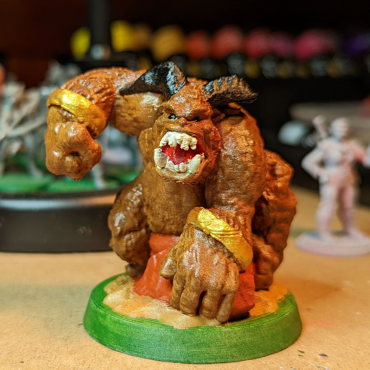 a miniature model of a barlgura, which looks like an angry monkey with horns.  it's just punched the ground and has its other fist balled to punch something else.