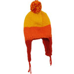 A knitted yellow and orange hat with a pompom on the top and red flaps on the sides.