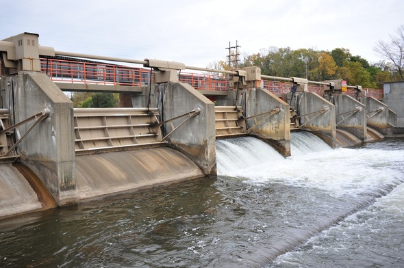 a low dam with a spillway, perhaps from ann arbor?  this was the picture supplied, so I don't know.

original URL
https://external-content.duckduckgo.com/iu/?u=http%3A%2F%2Fwww.annarbor.com%2Fassets_c%2F2010%2F10%2FArgo_Dam_Oct_2010_2-thumb-590x392-57538.jpg&f=1&nofb=1