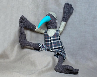 a stuffie with dark black body and thin blue head? so this stuffie with a beak, 3-toed feet, and plaid body came from a google image search for 'cassowary stuffie' and links to Etsy. but, nothing on the landing page of the link looked anything like this image